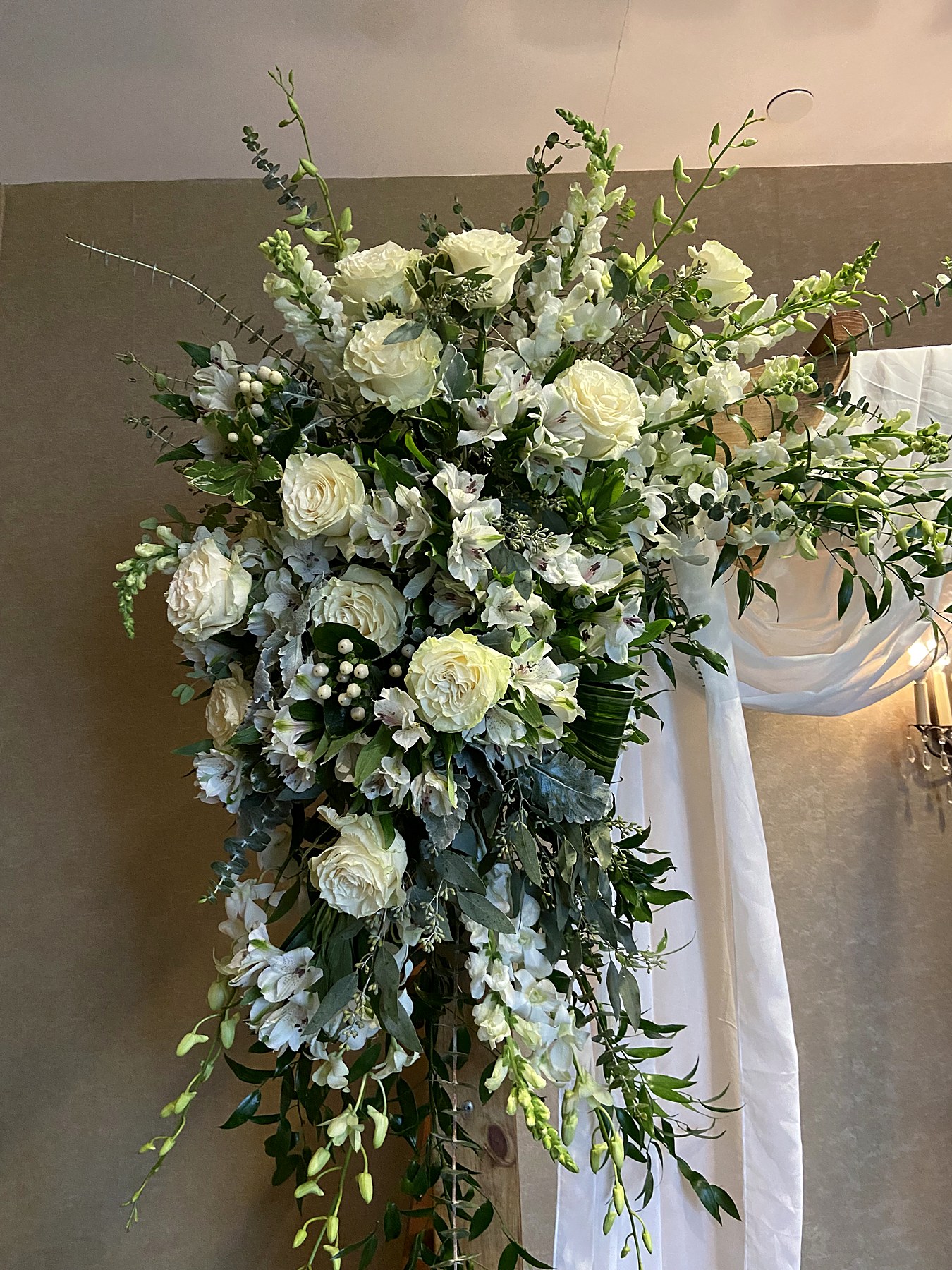 White rose and greenery ceremony arch spray, detail