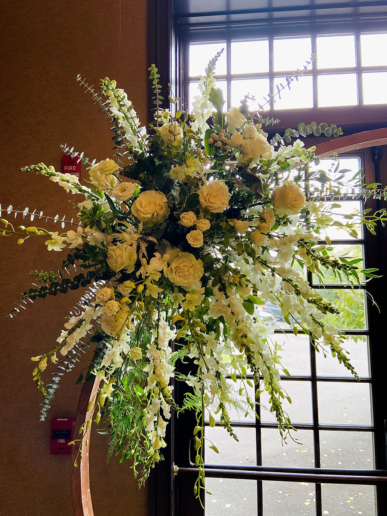 Cascading ivory rose and greenery arch spray