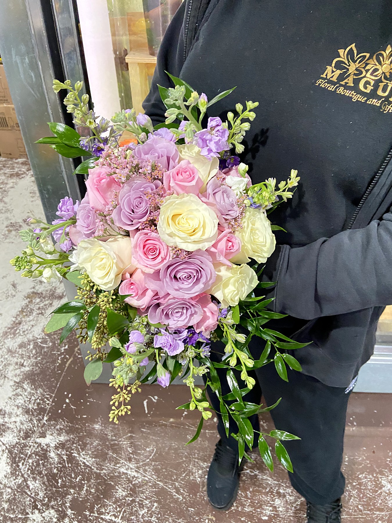 Bridal bouquet in blush, lavender, and ivory roses