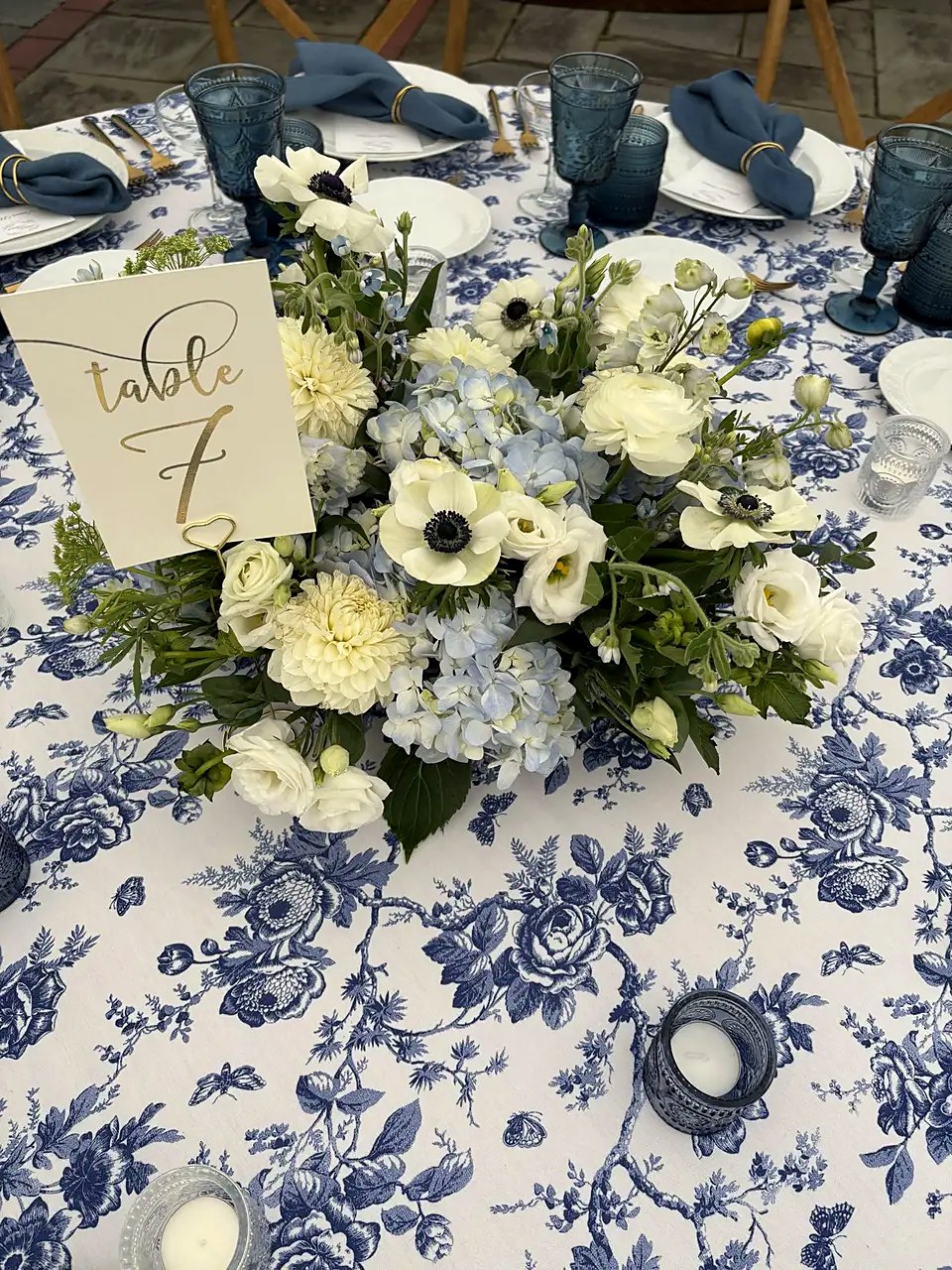 Table 7 centerpiece with blue hydrangea, anemones, and dahlias